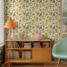 richly detailed botanical pattern featuring golden florals, leafy greens, birds, and butterflies