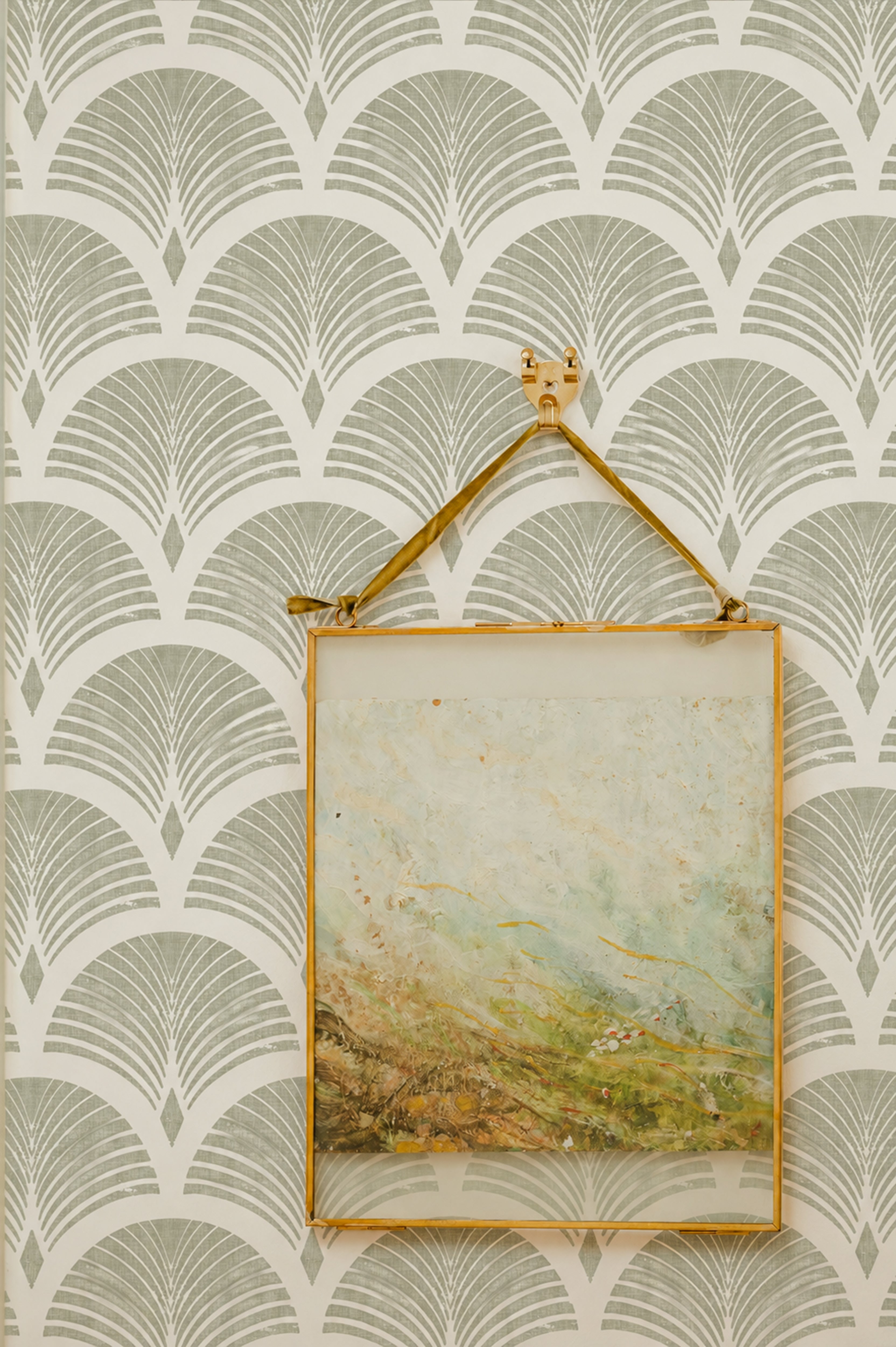 repeating olive green fan arches, fine radiating lines, and lightly distressed detailing on a warm ivory ground