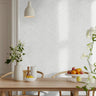 Subtle distressed beige leaves on white background in warm and bright living room