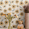 Yellow and golden daisies with green stems on off white background in kids nursery with cube shelves behind tulips and teddy bear