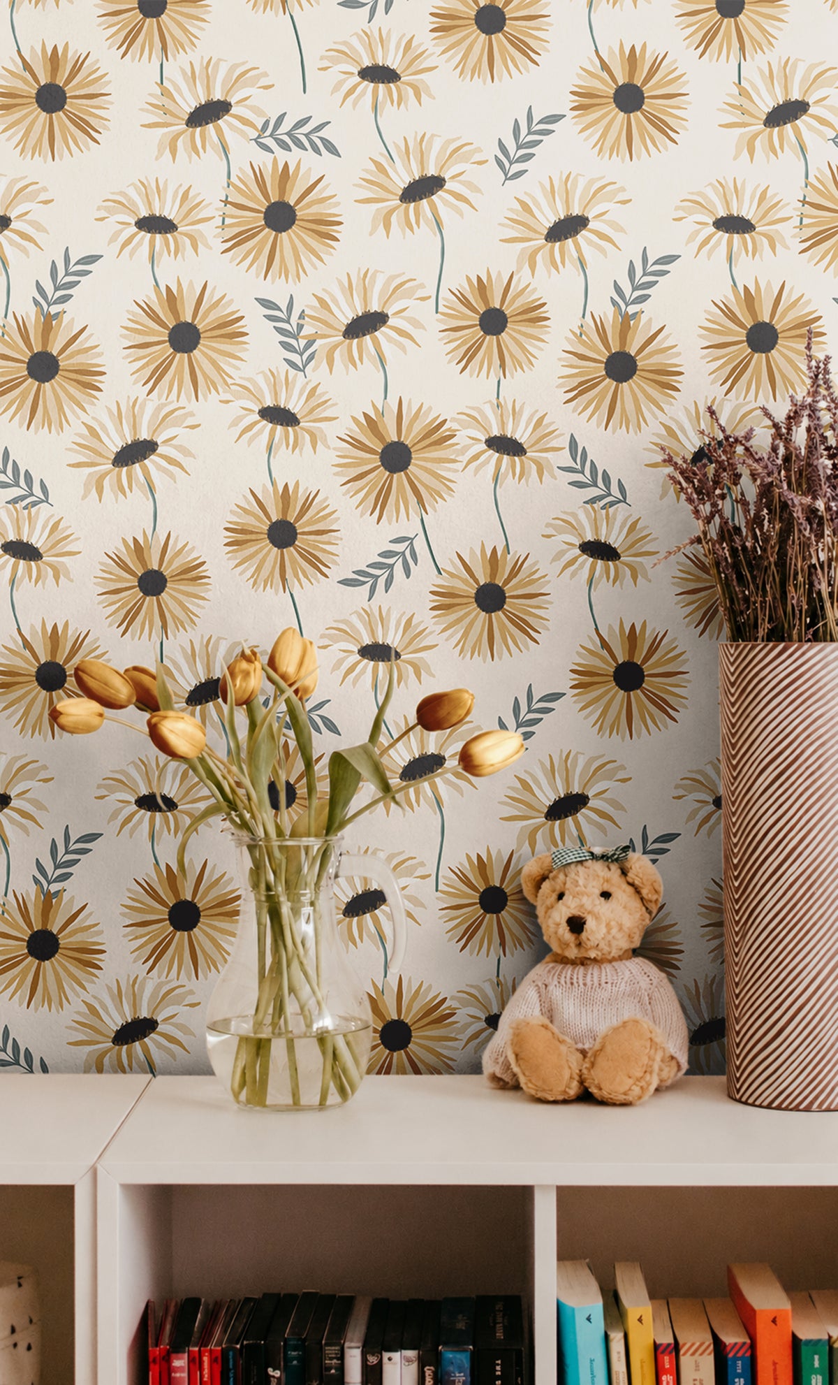 Yellow and golden daisies with green stems on off white background in kids nursery with cube shelves behind tulips and teddy bear