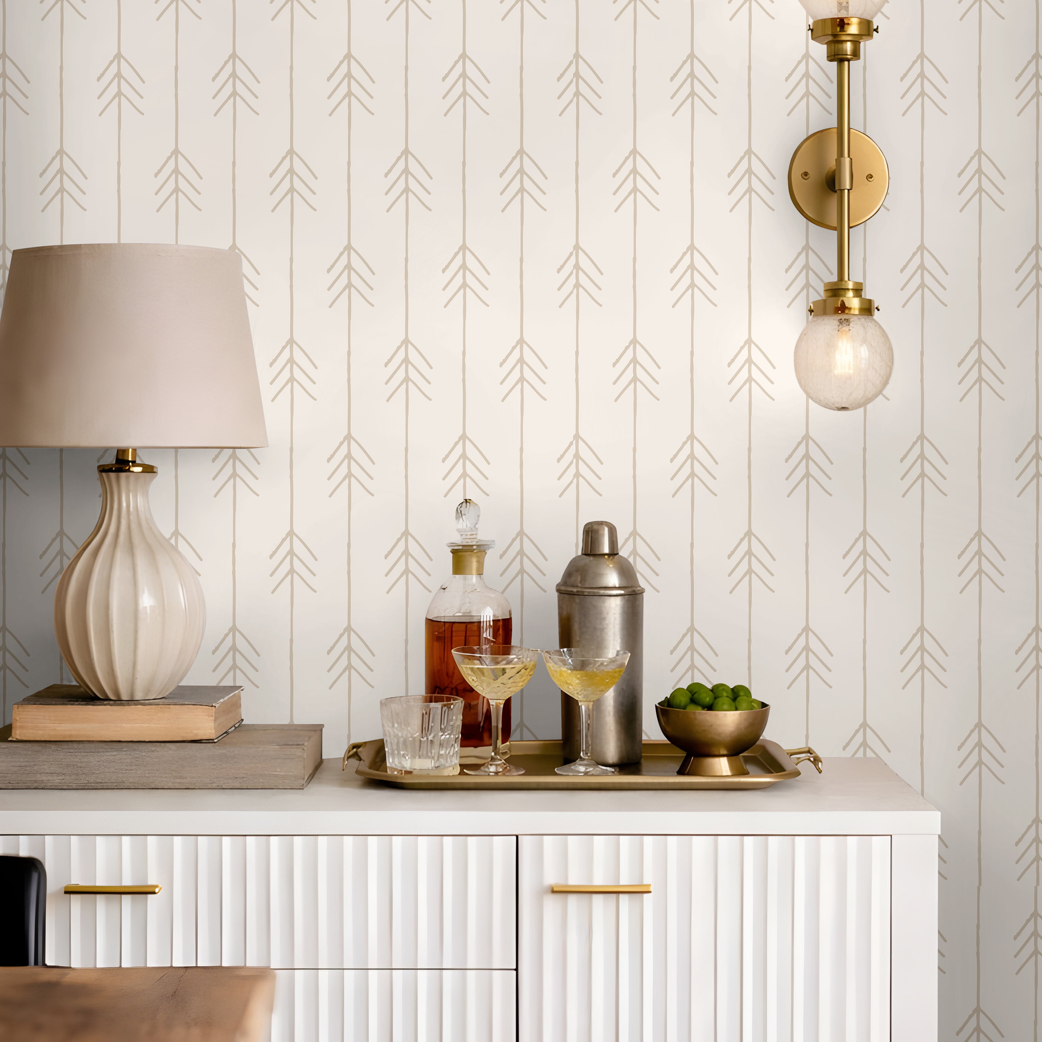 Beige tan vertical arrows on cream, white background in living space styled behind bar cart credenza
