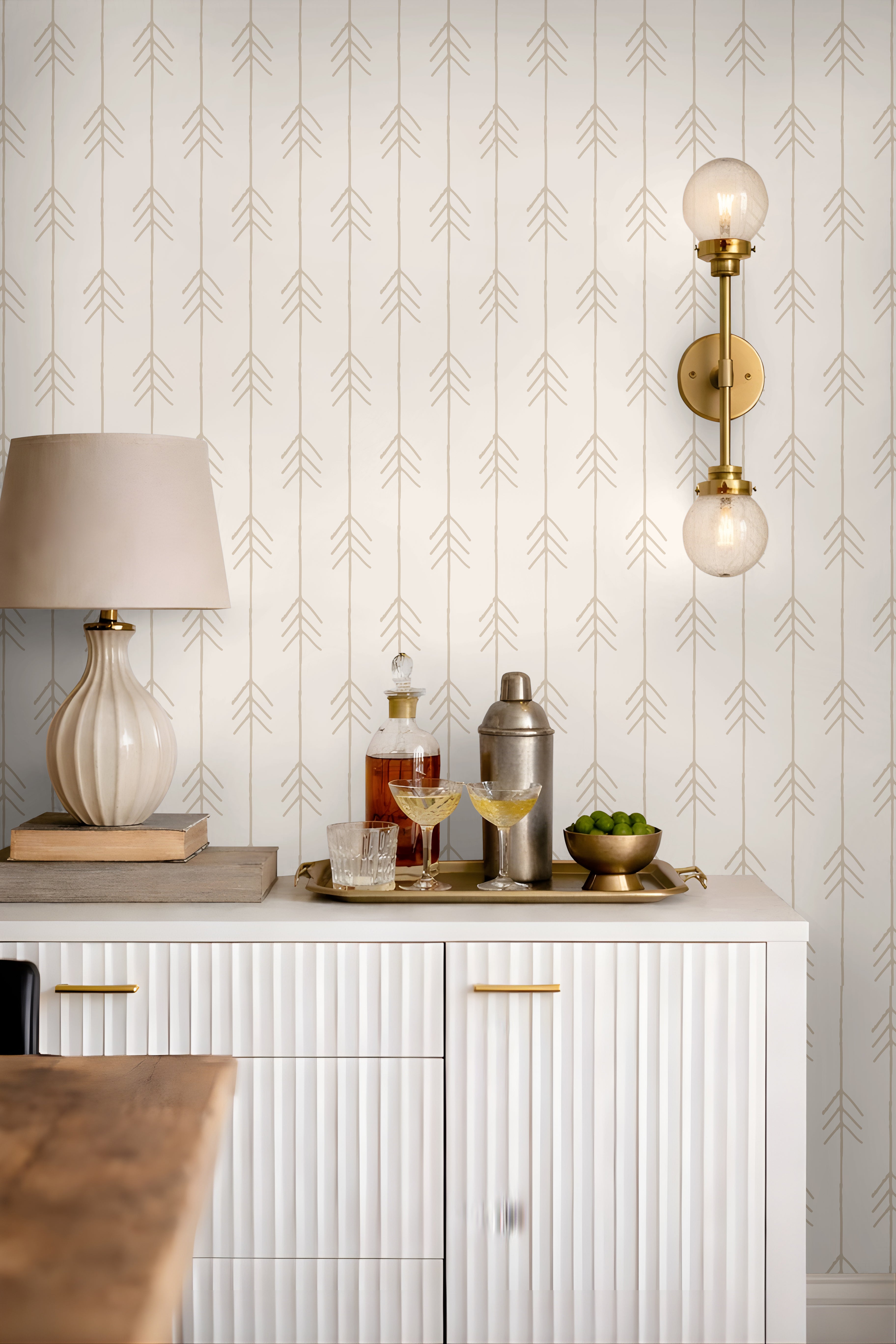 Beige tan vertical arrows on cream, white background in living space styled behind bar cart credenza