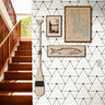black geometric triangle outlines on white background in well lit nautical hallway