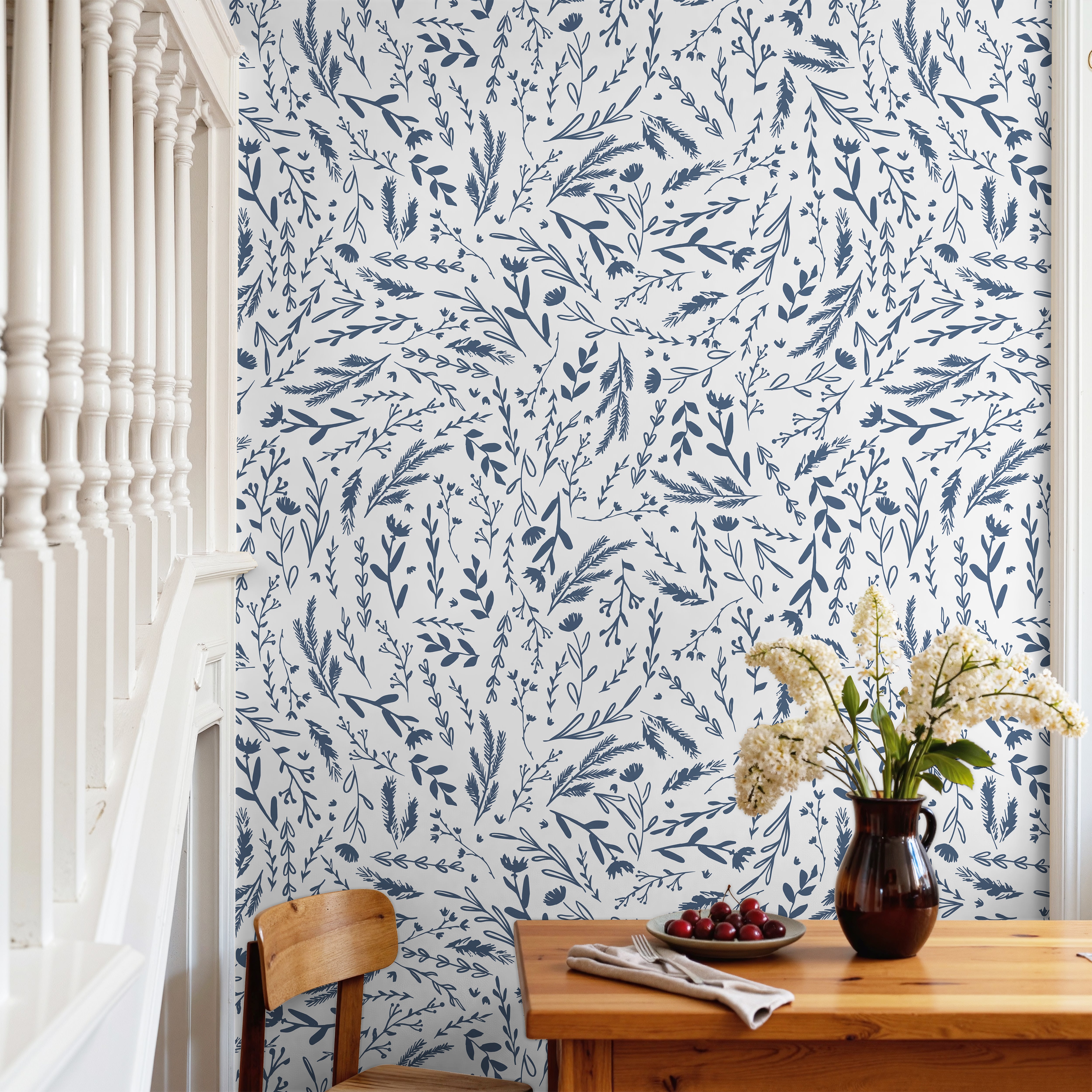 Blue wildflowers and leaves on white background in warm dining room