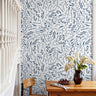 Blue wildflowers and leaves on white background in warm dining room