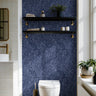 Blue and white zigzag stripes accent wall with shelves in modern bathroom