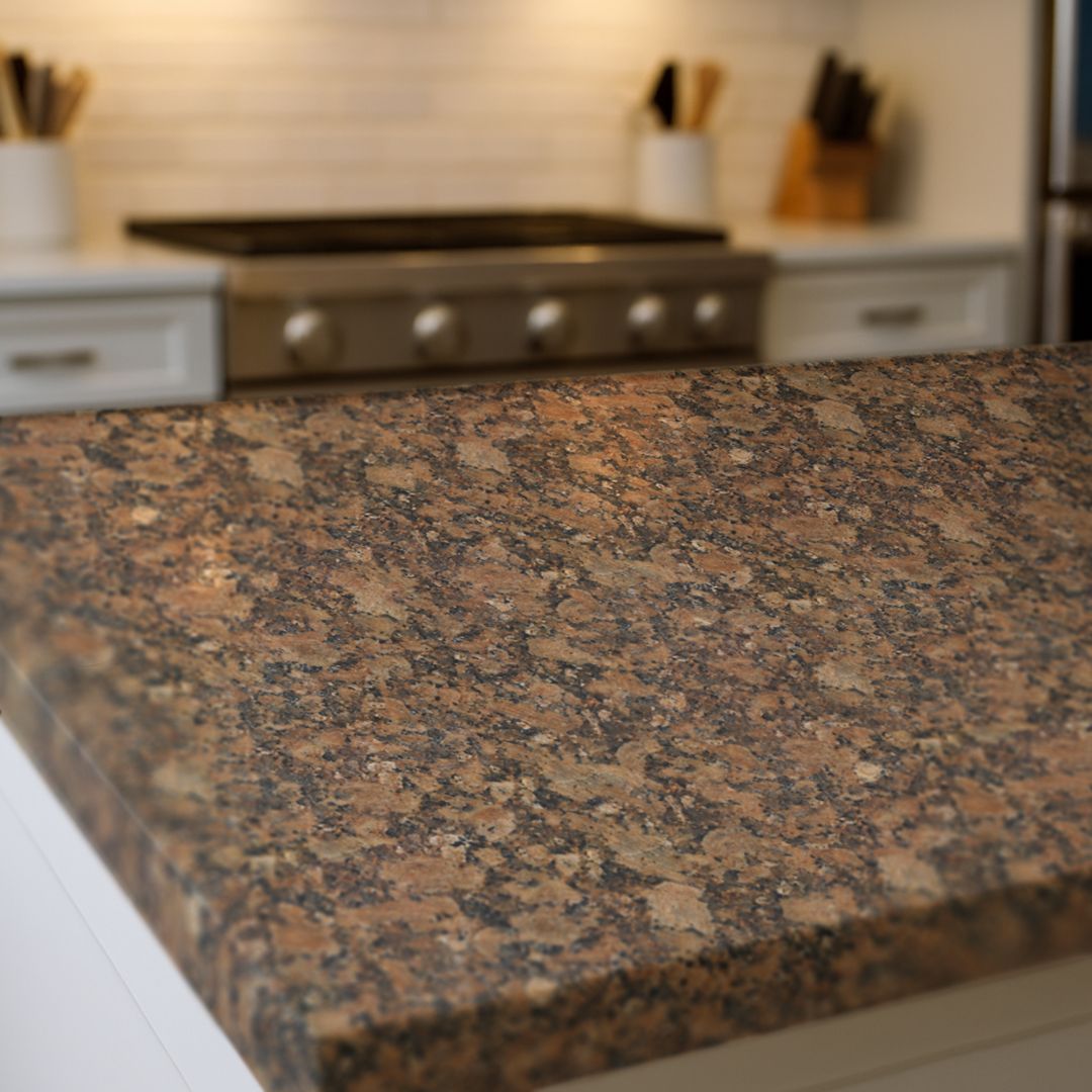 Close up of Amberstone Granite countertop film 83 showing warm brown and charcoal stone detail
