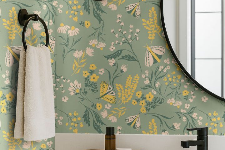 buttercup bloom sage green floral wallpaper with yellow and white flowers in a modern bathroom vanity with round mirror and black fixtures