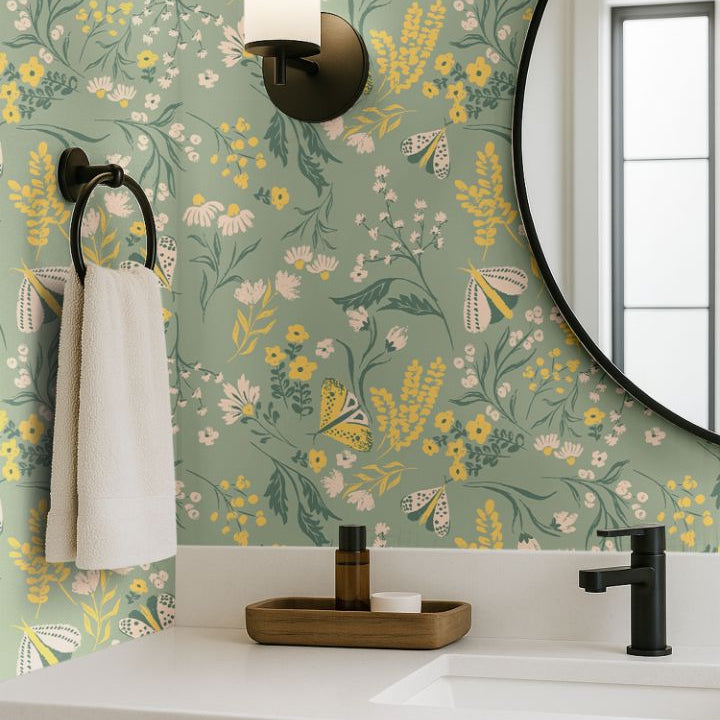 buttercup bloom sage green floral wallpaper with yellow and white flowers in a modern bathroom vanity with round mirror and black fixtures