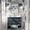 Baywell blue floral wallpaper with navy botanical flowers styled above a blue bathroom vanity with brass fixtures.