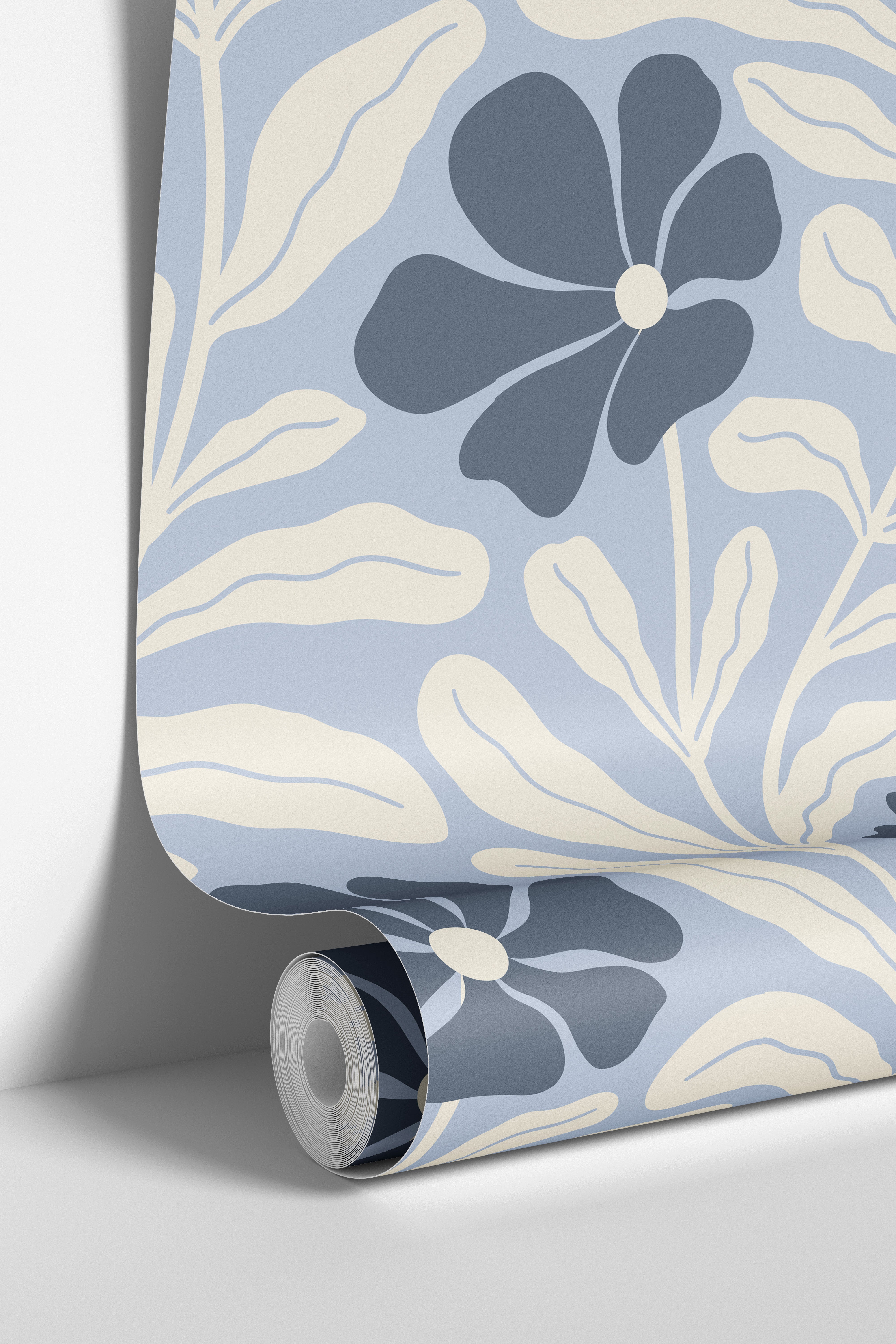 Wallpaper roll mockup of Baywell light blue and navy floral wallpaper with cream botanical leaves by James & Colors.