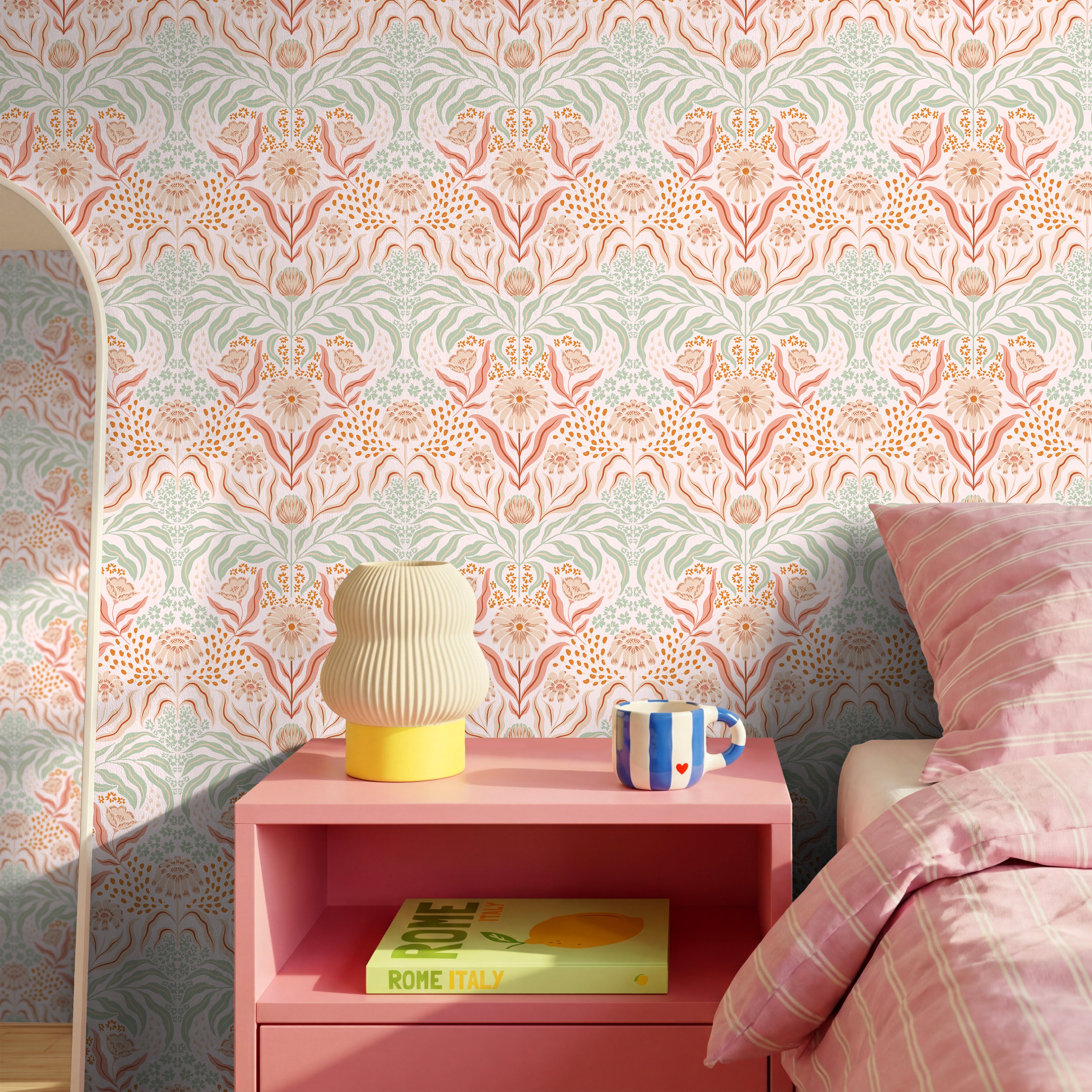 Soft peach and sage floral wallpaper in a feminine vintage-inspired bedroom with warm neutral decor.