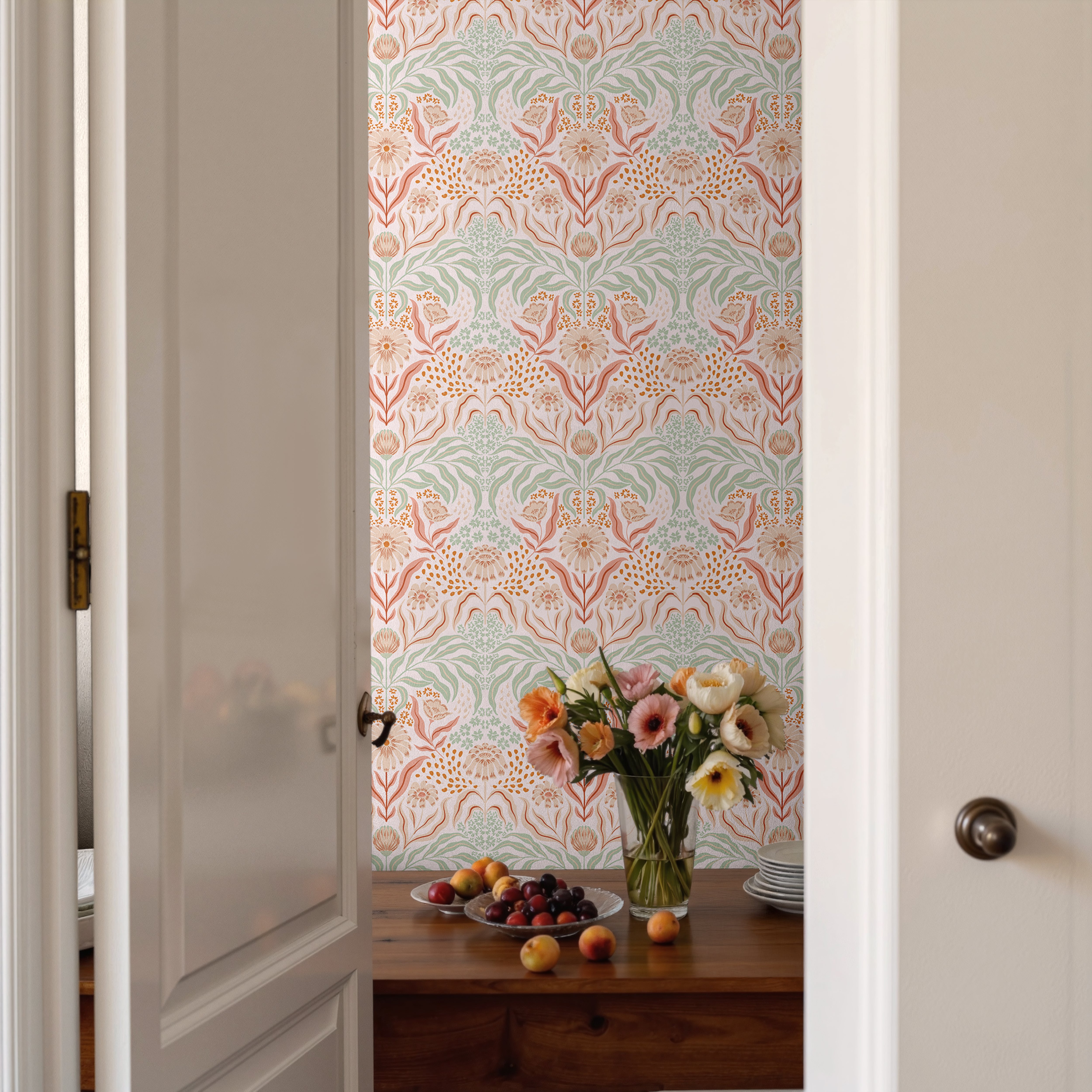 Vintage botanical wallpaper with peach flowers and sage greenery in a warm cottage-inspired dining room.