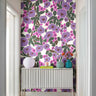 Bloom Society wallpaper installed in a modern interior featuring bold lavender and magenta florals