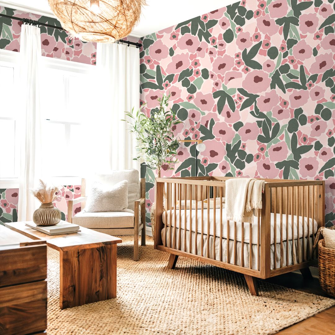 Light-filled nursery with Blossom Nook Wallpaper, blending blush florals and greenery for a modern, cozy design.