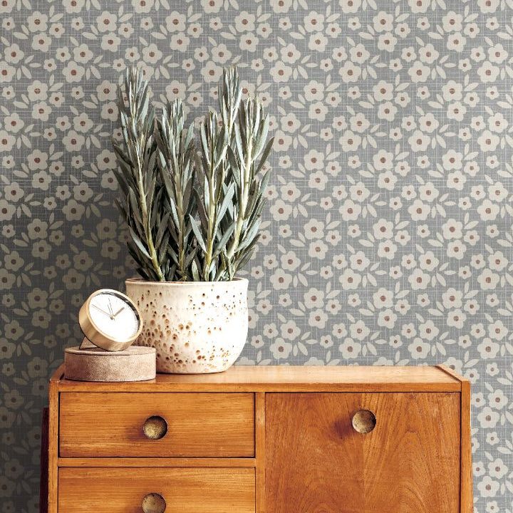 bluebell haven floral wallpaper styled behind mid century wood sideboard with potted plant