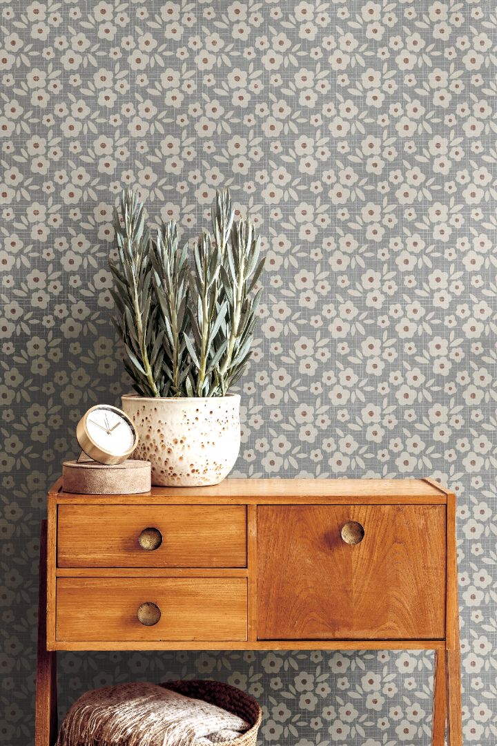 bluebell haven floral wallpaper styled behind mid century wood sideboard with potted plant