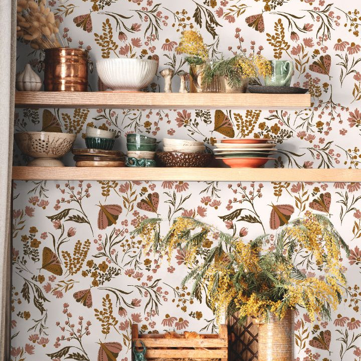 Close view of Brassmere Wilds botanical wallpaper pattern with brass toned florals, butterflies, and sage botanical stems.