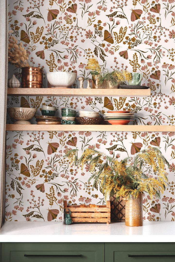 Close view of Brassmere Wilds botanical wallpaper pattern with brass toned florals, butterflies, and sage botanical stems.