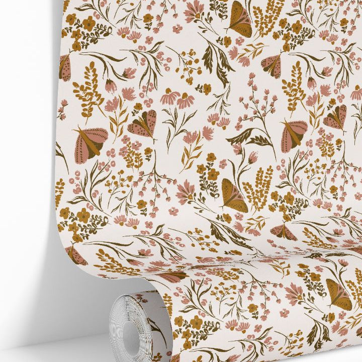 Wallpaper roll displaying Brassmere Wilds botanical wallpaper pattern with wildflowers and butterflies.