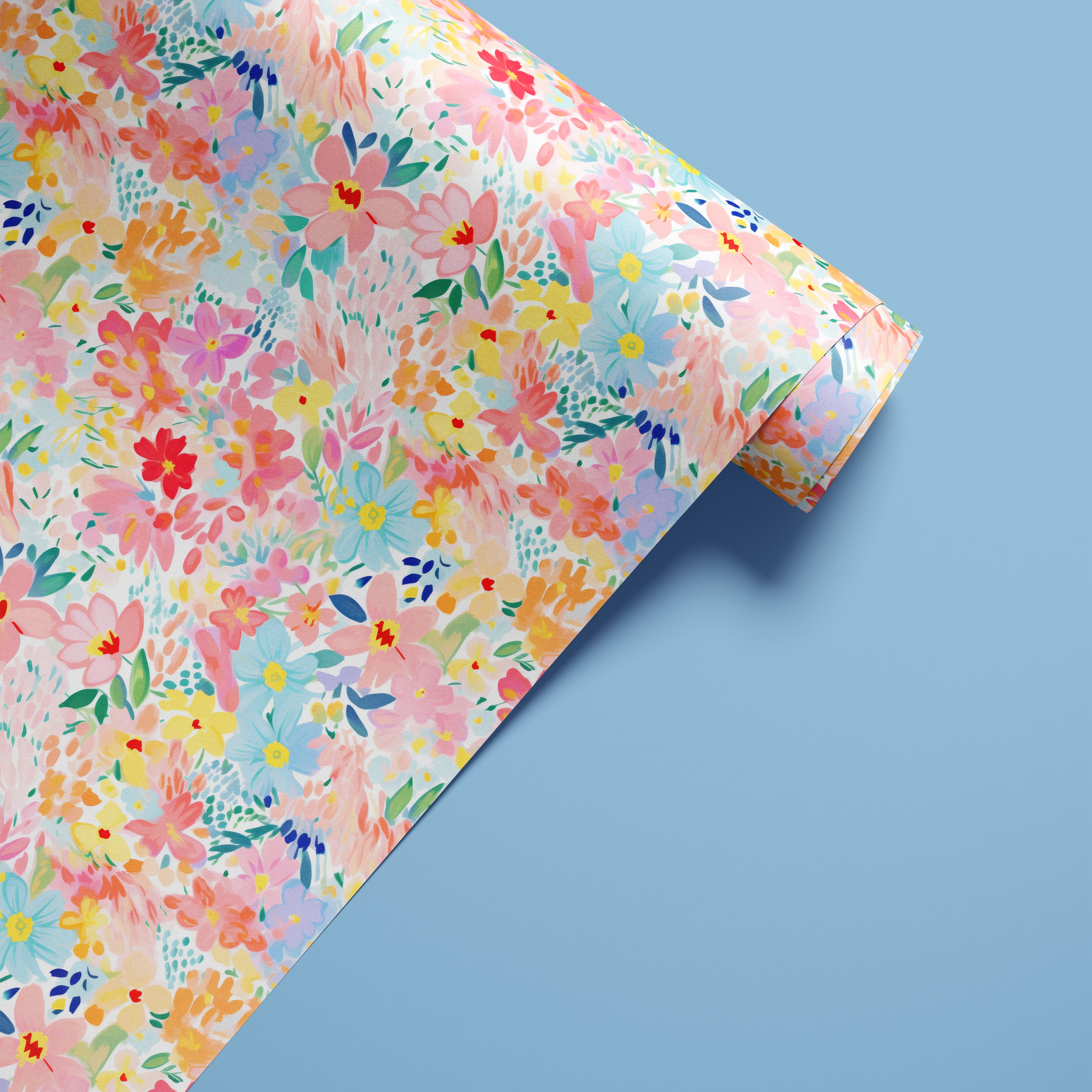 Colorful pastel floral contact paper with painterly pink, blue, coral, and yellow flowers shown in a styled product roll