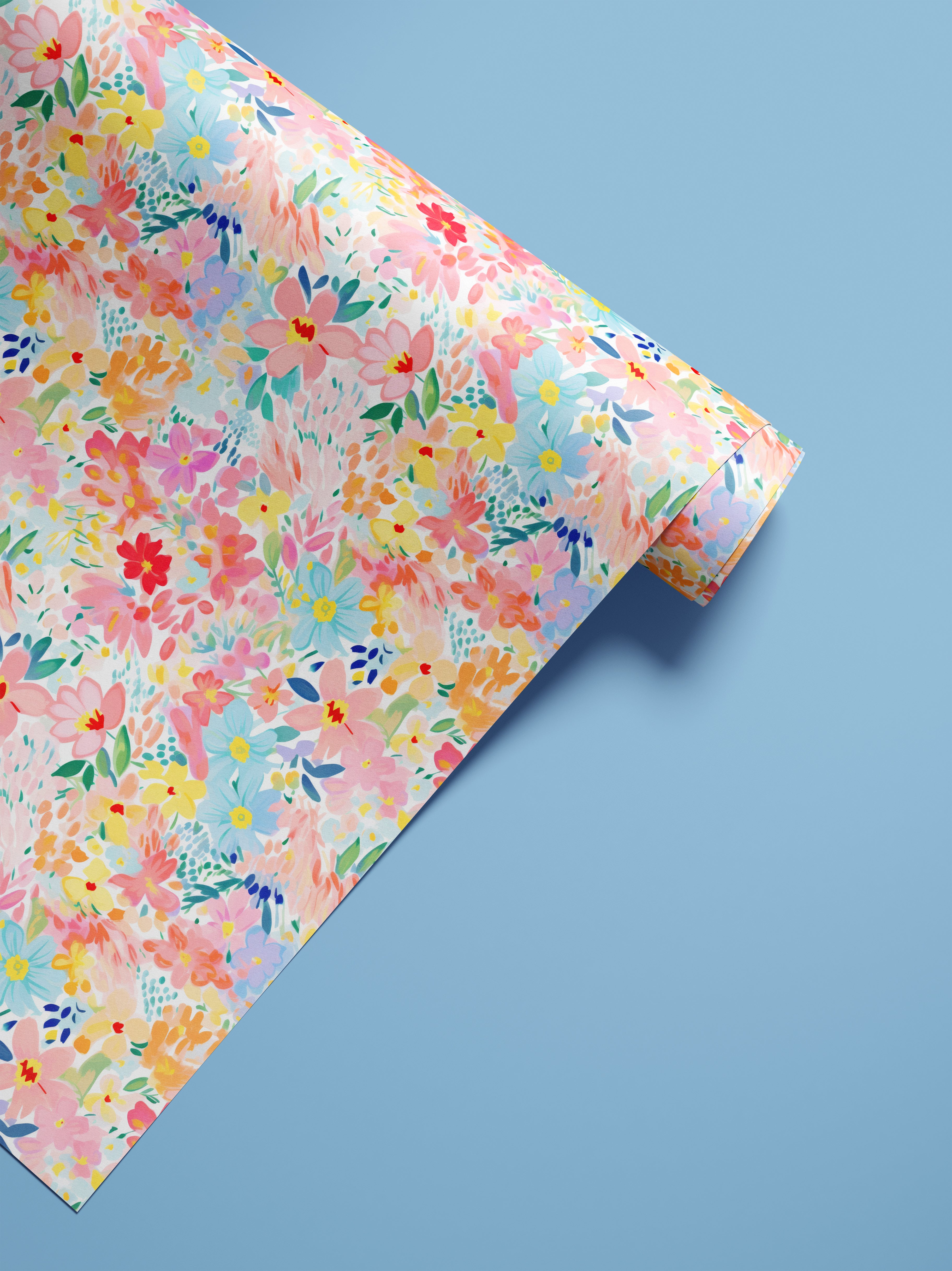 Colorful pastel floral contact paper with painterly pink, blue, coral, and yellow flowers shown in a styled product roll