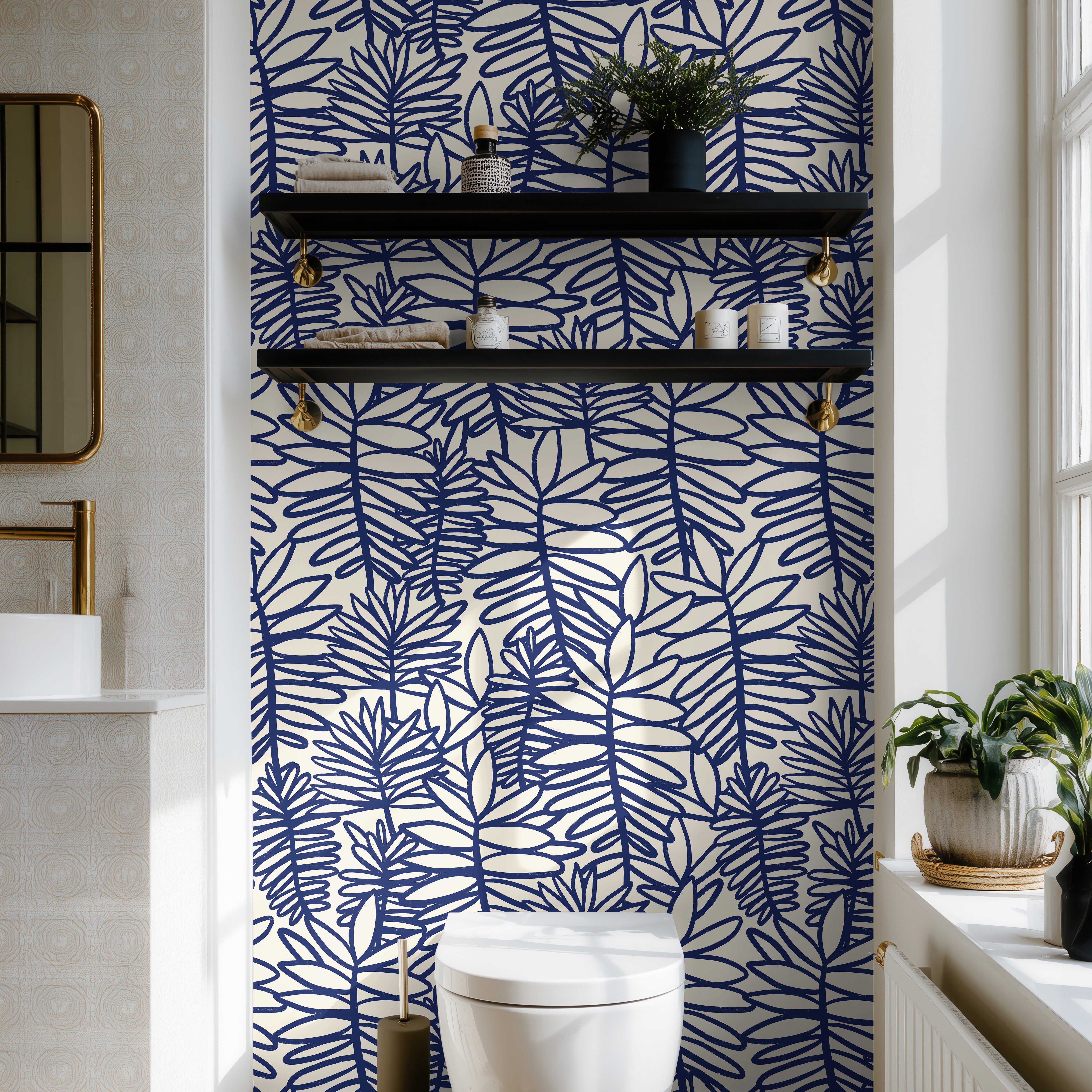 Blue botanical wallpaper with oversized tropical foliage styled in a bright coastal bathroom.