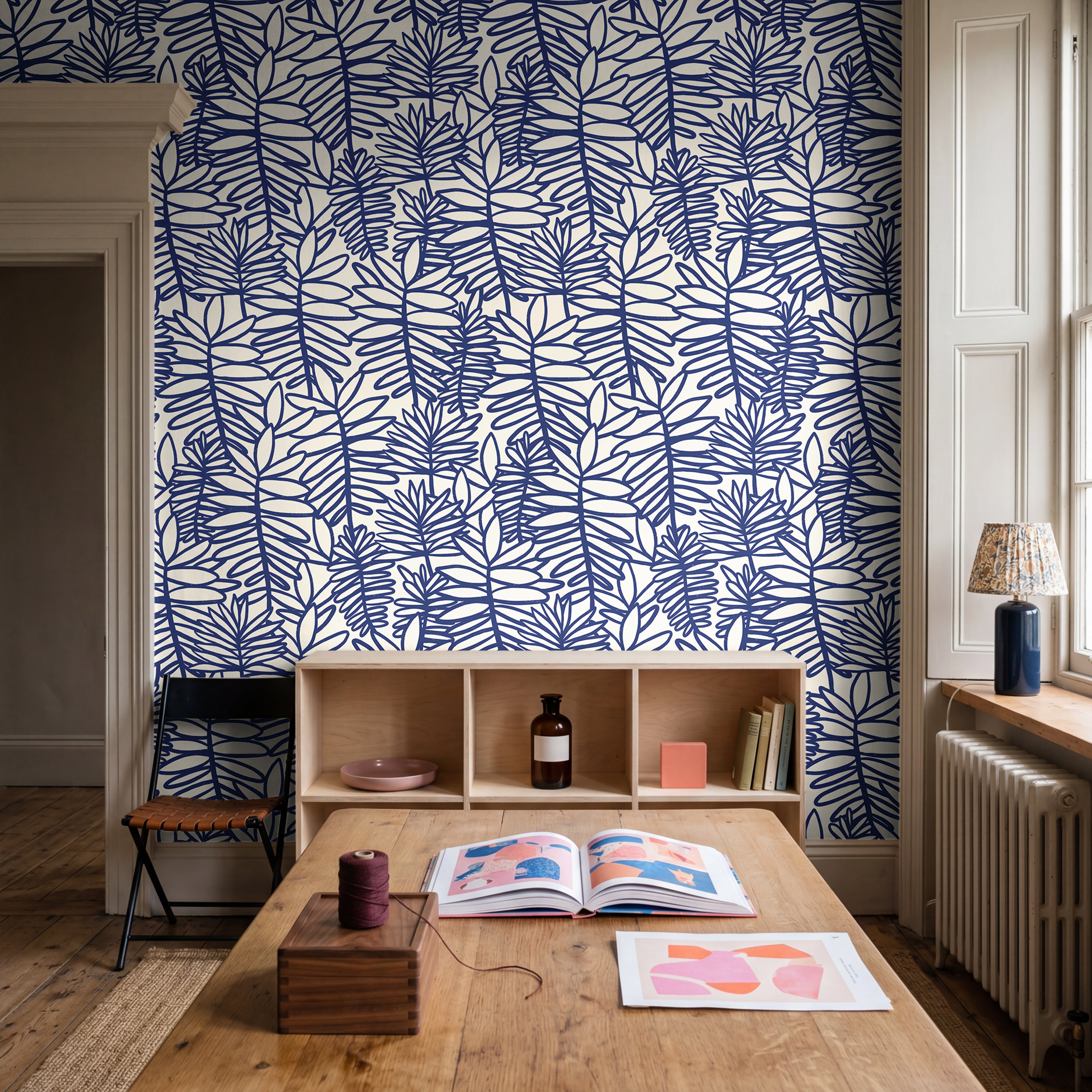 Blue tropical wallpaper styled in a sophisticated dining room with natural textures and coastal decor