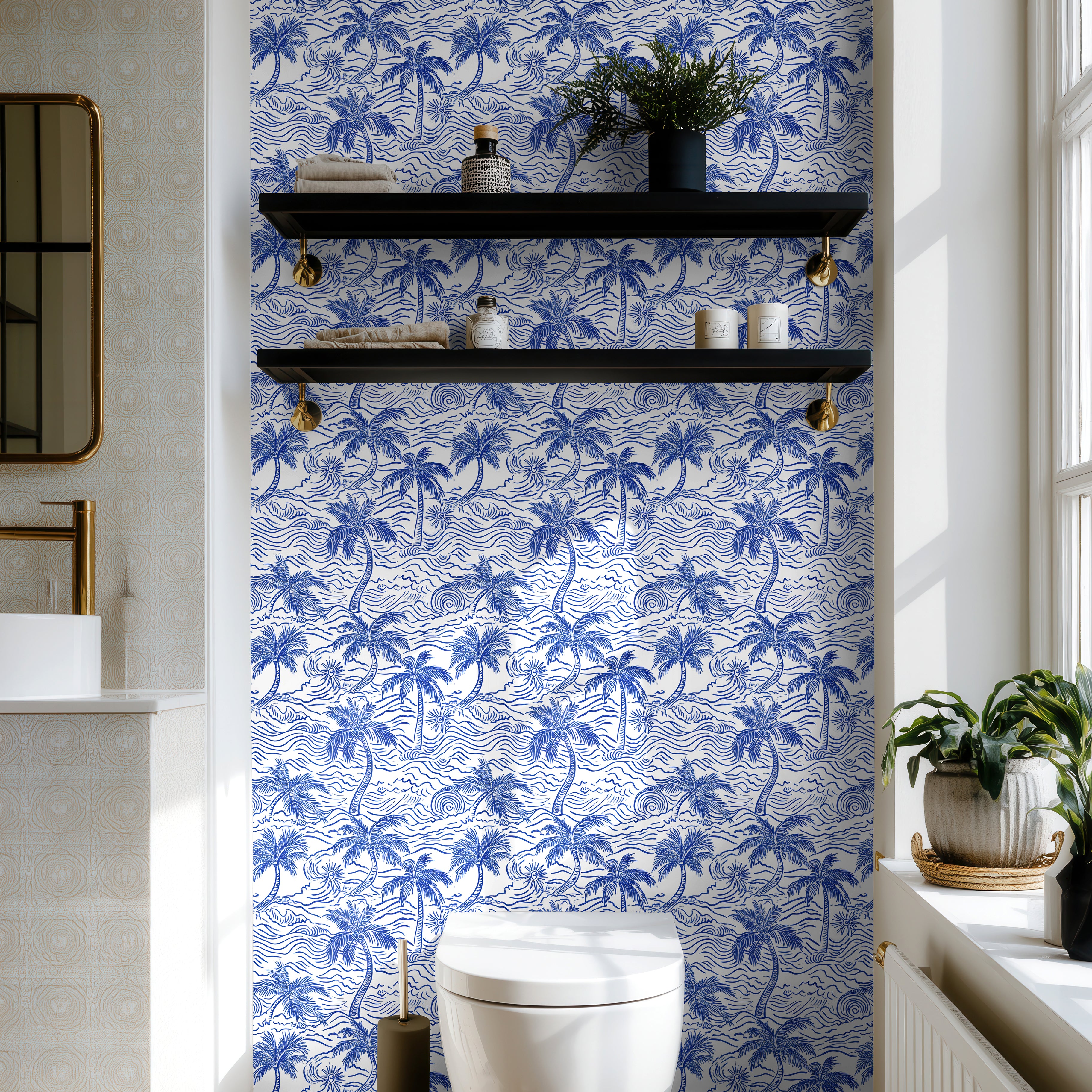 Coastal blue palm wallpaper styled in a bright powder bathroom with brass fixtures and modern decor.
