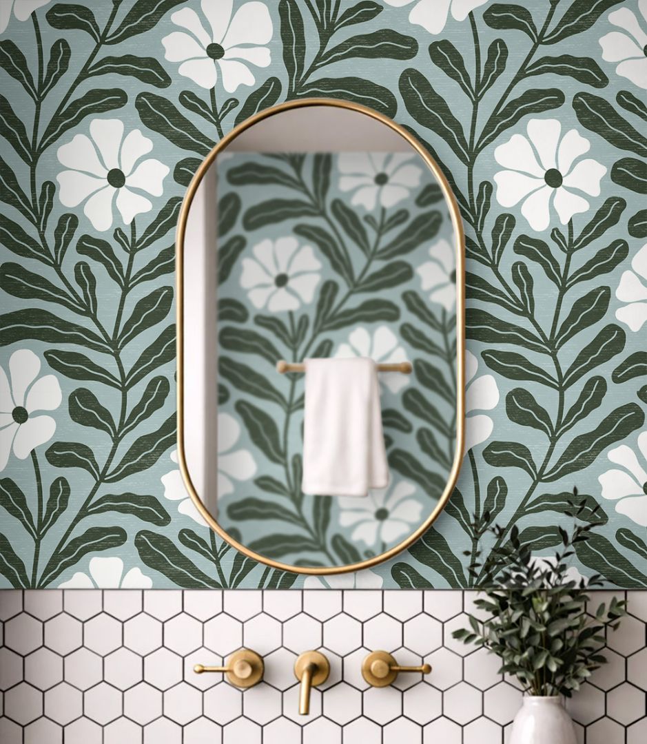 Close up of Driftwell floral wallpaper showing cool green botanical leaves and ivory flowers