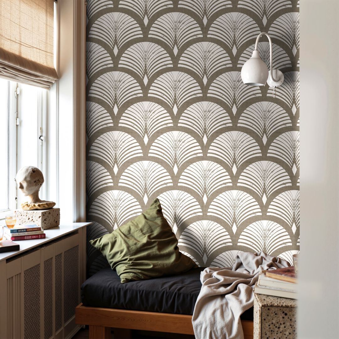 taupe and ivory art deco fan wallpaper behind window seat with olive pillow and books