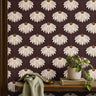 garnet crown 3543 burgundy coneflower wallpaper behind wood shelf with green plant books and sage fabric