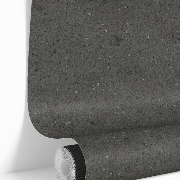 Graphite Terrazzo Collective wallpaper roll showing dark charcoal stone speckled pattern
