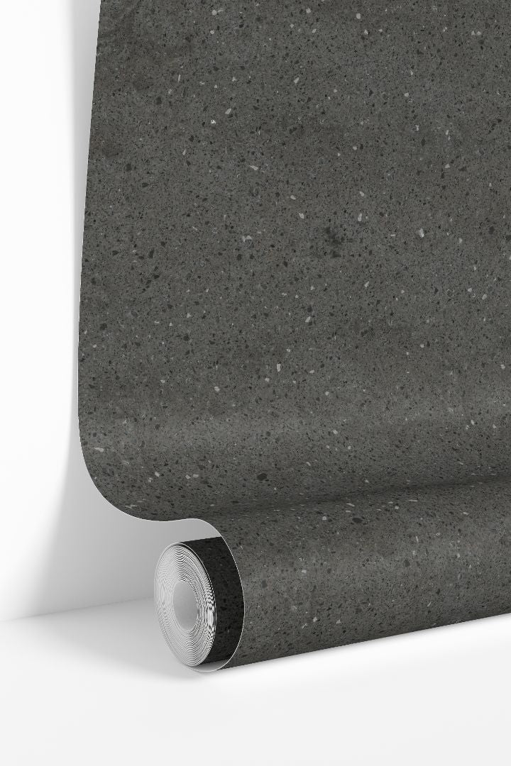 Graphite Terrazzo Collective wallpaper roll showing dark charcoal stone speckled pattern