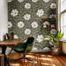 greenwell olive floral wallpaper in cozy dining nook with warm wood accents – large scale botanical pattern – james & colors