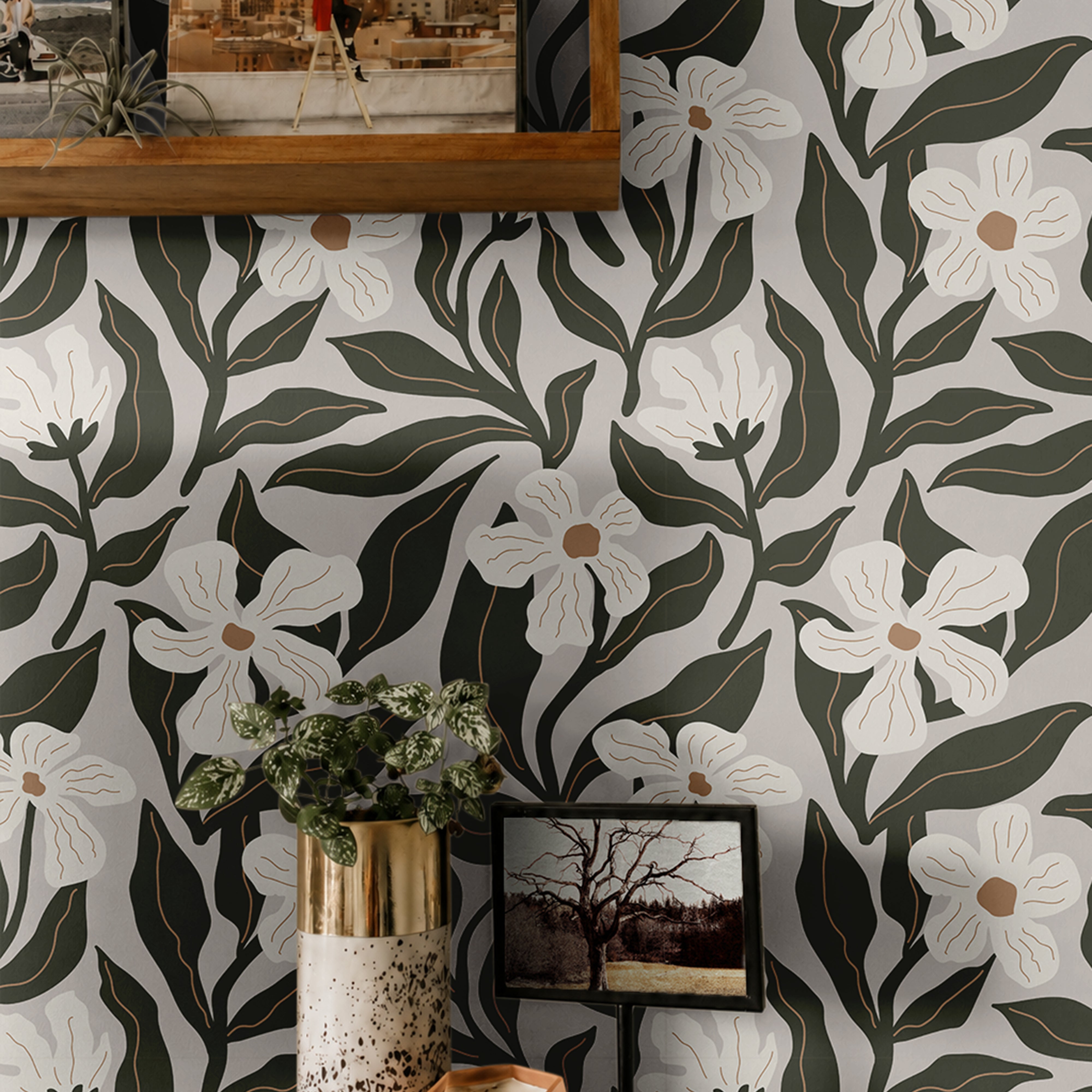  ivory flowers with tan centers and dark olive leaves on a pale wallpaper background behind warm wooden shelves
