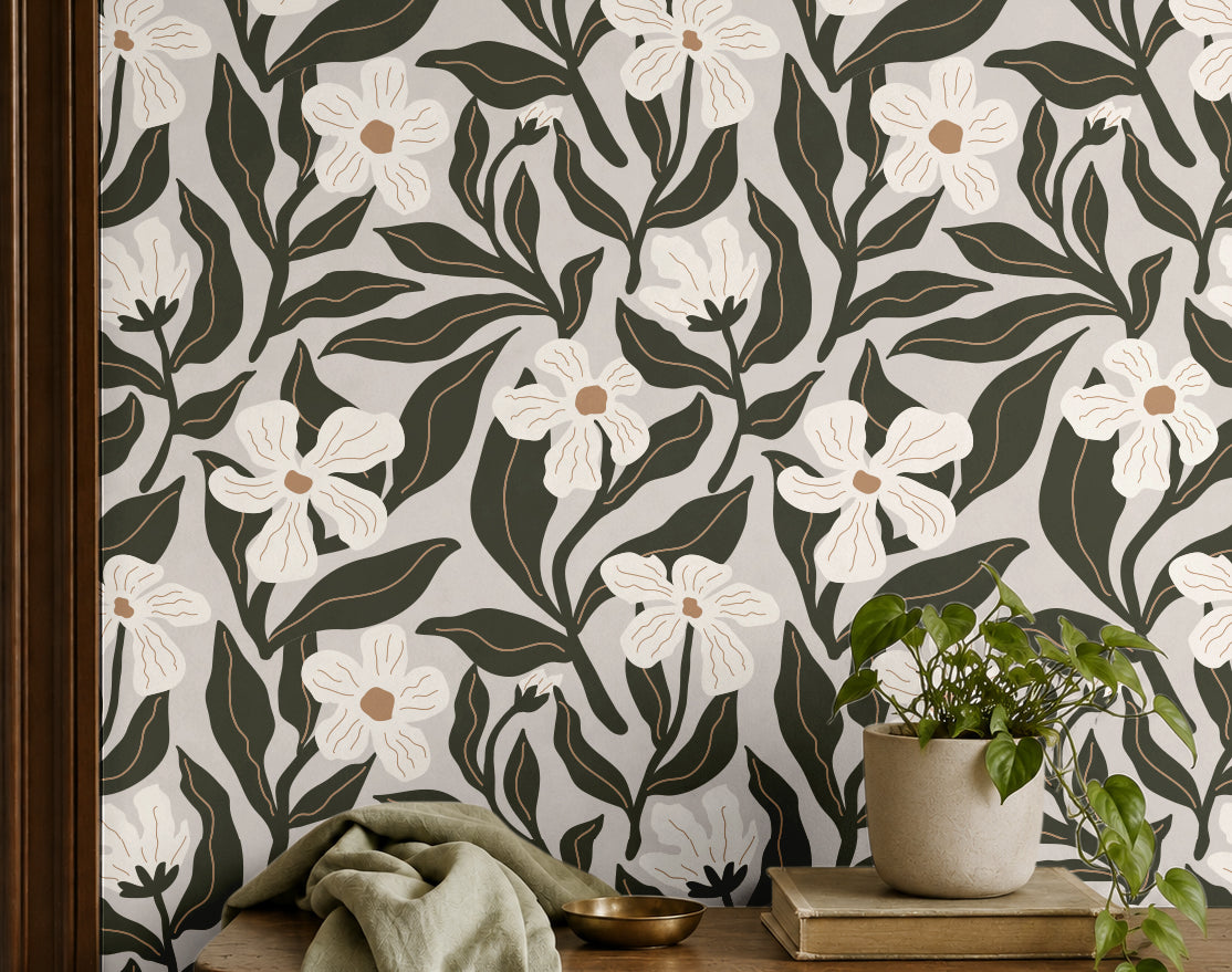 ivory floral wallpaper with dark olive leaves behind a wood shelf with potted plant