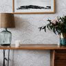 close view of harbor passage wallpaper with muted blue curling waves ivory linework and distressed texture