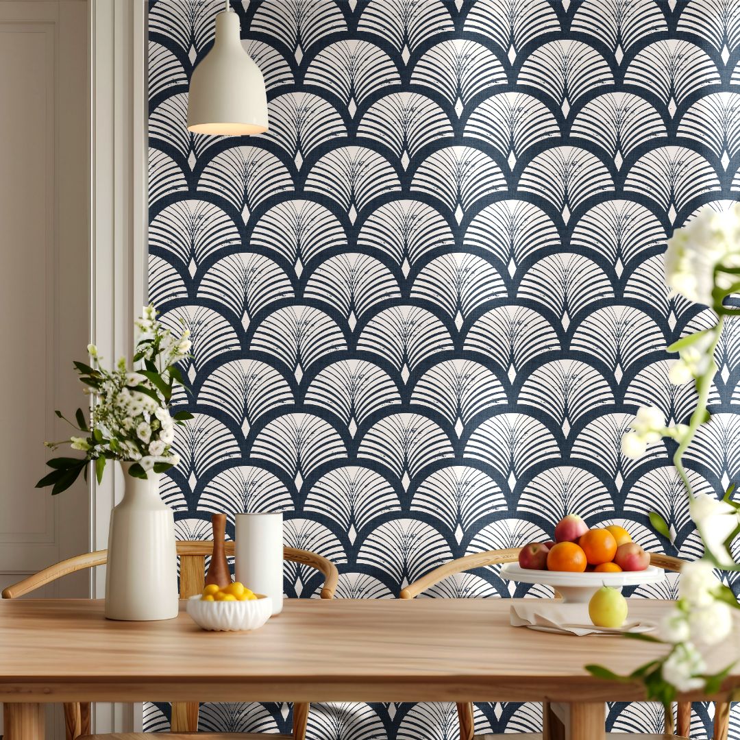 harborcroft navy art deco wallpaper behind wood dining table with flowers and fruit