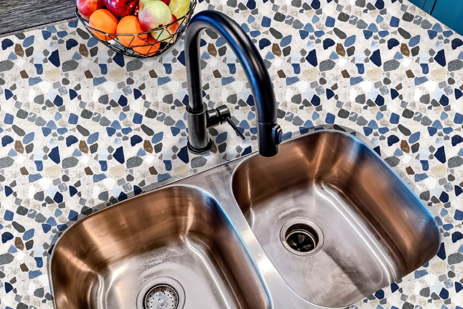 Terrazzo countertop film with blue and gray stone pattern around stainless steel sink