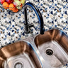 Terrazzo countertop film with blue and gray stone pattern around stainless steel sink