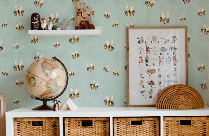 bee wallpaper with playful whimsical bees on teal wall in nursery storage space