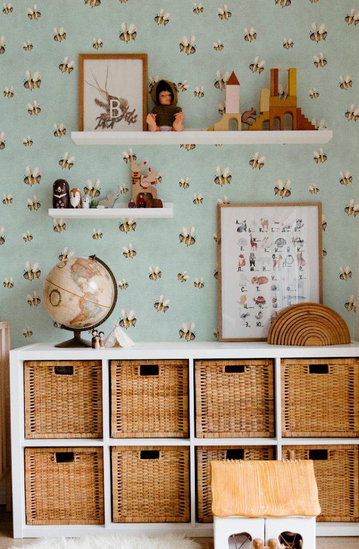 bee wallpaper with playful whimsical bees on teal wall in nursery storage space