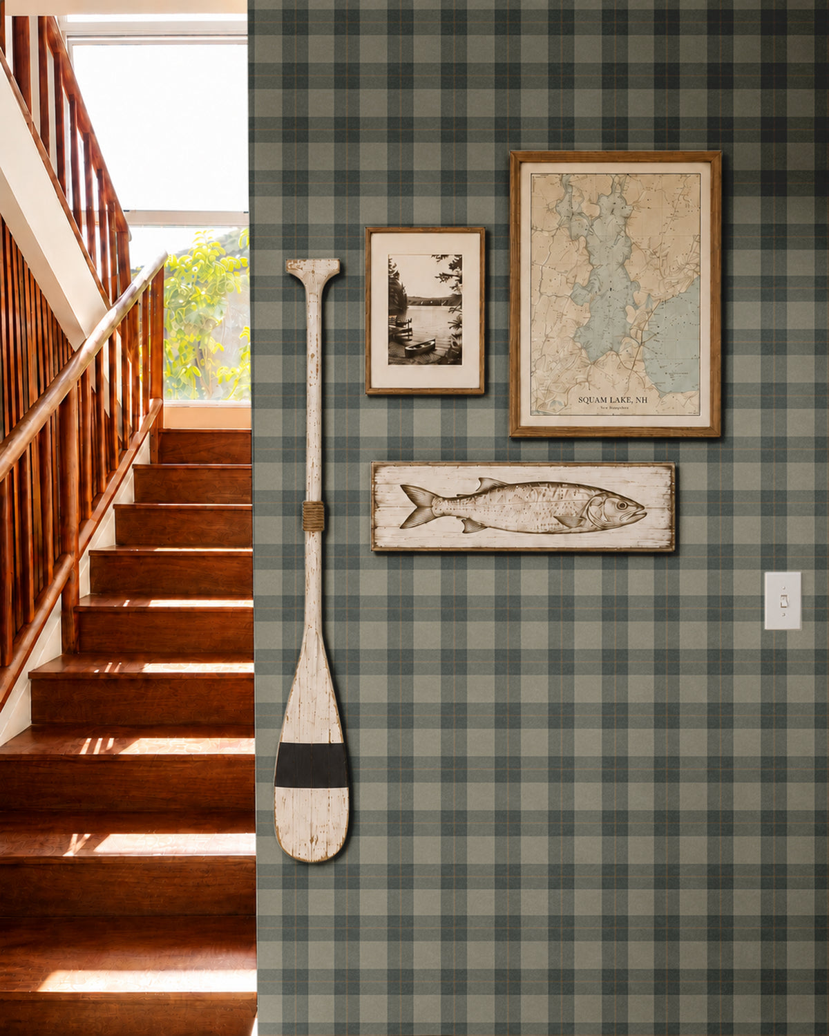 olive, gray, and charcoal plaid wallpaper in stair hall with warm wood stairs vintage lake art and paddle