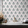 Indigo botanical wallpaper with fan shaped florals, blush accents, and green stems arranged in a repeating pattern on a soft ivory background.