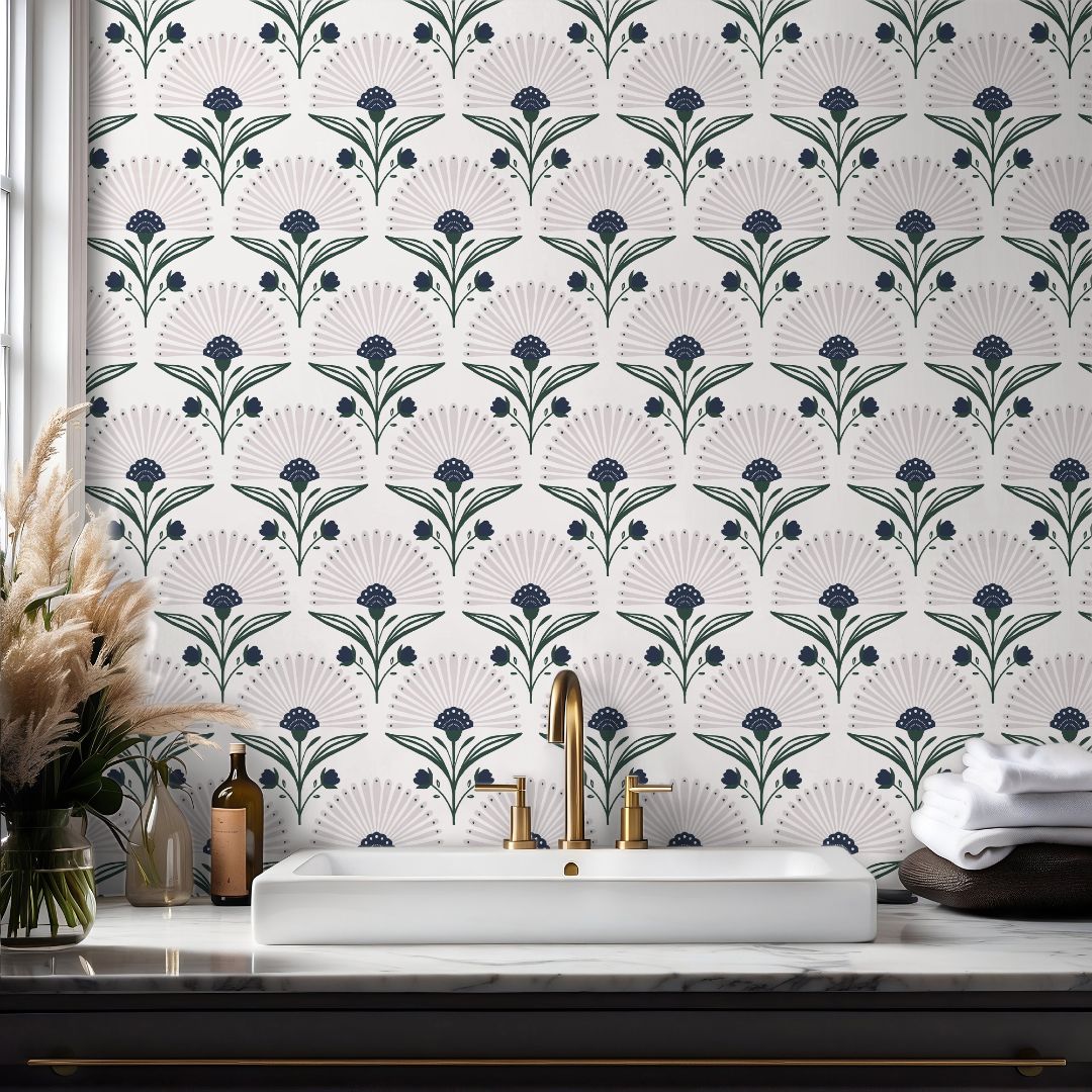  indigo floral wallpaper above white sink with brass faucet marble counter and pampas grass