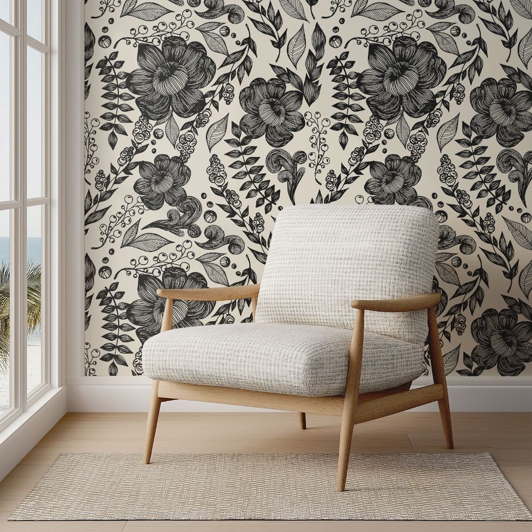 Inkwell Botanica wallpaper featuring bold hand-drawn black florals behind neutral armchair