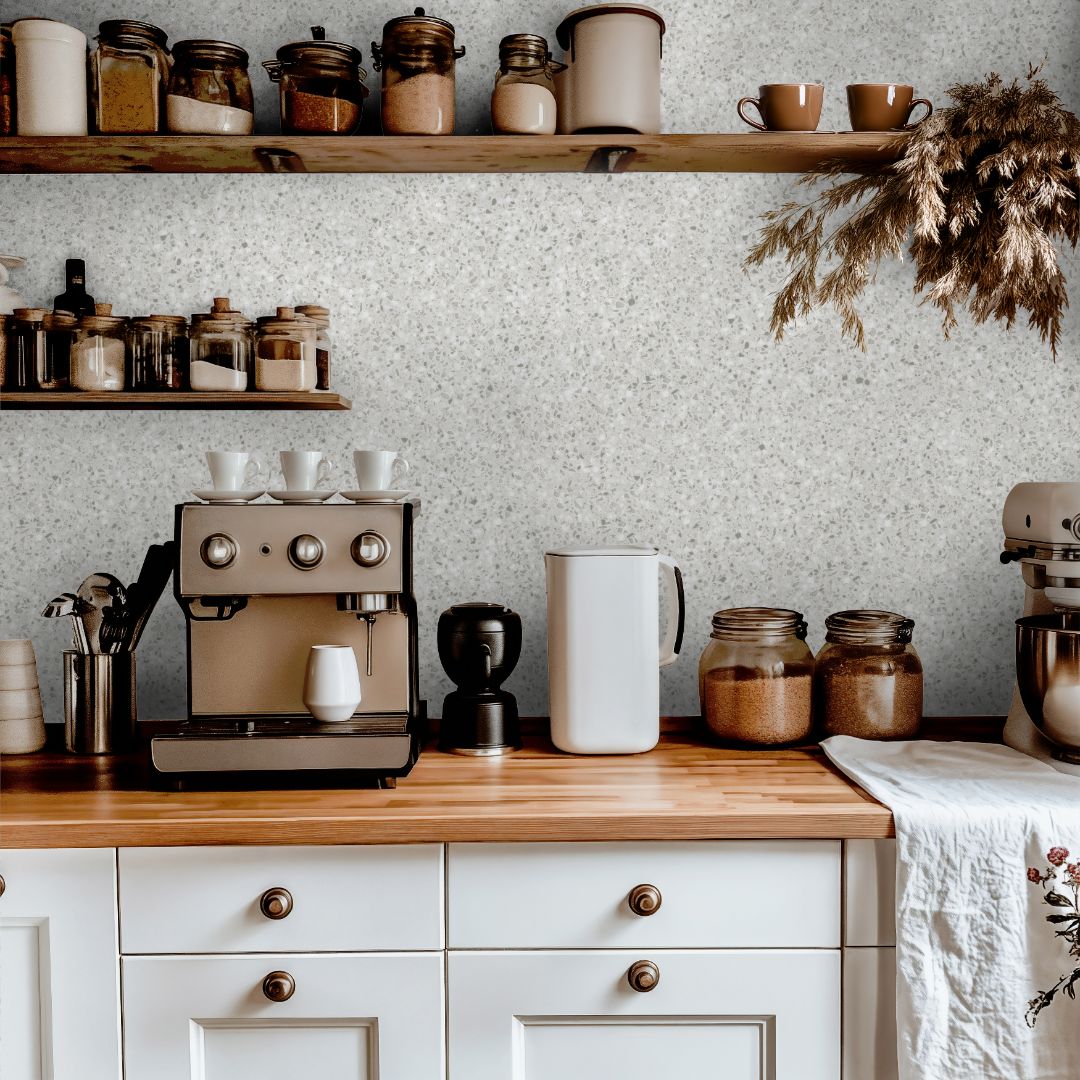 Bright neutral terrazzo wallpaper with soft speckled pattern in a clean minimalist interior