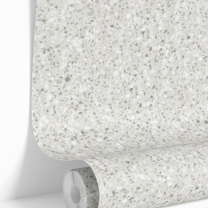 Ivory Terrazzo Collective wallpaper roll showing light neutral stone speckled pattern